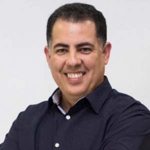 Jose smiling in a black button down shirt
