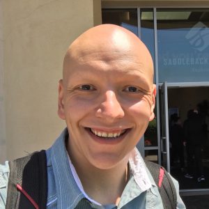 Ruben outside smiling with a backpack on