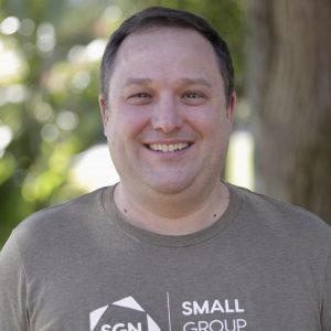 Brian smiling outside in a SGN t-shirt